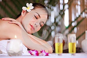 woman having massage in the spa salon, beauty, health care body skin natural herbs and essential oils treatment. concept