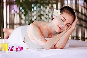woman having massage in the spa salon, beauty, health care body skin natural herbs and essential oils treatment. concept