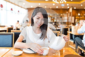 Woman having meal in chinese restaurant