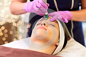 Woman having microdermabrasion facial treatment