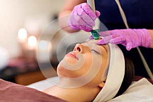 Woman having microdermabrasion facial treatment