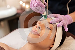 Woman having microdermabrasion facial treatment