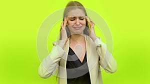 Woman having migraine crying in studio wall