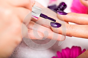 Woman having a nail manicure in a beauty salon