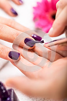 Woman having a nail manicure in a beauty salon