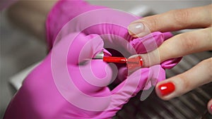 Woman Having a Nail Manicure In a Beauty Salon With a Close Up View Of a Beautician Applying Varnish With An Applicator