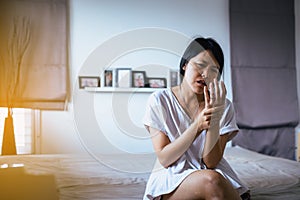 Woman having a neck her hand,Female feeling exhausted and painful on bedroom