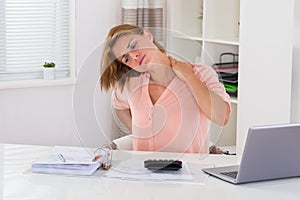 Woman Having Neckache At Desk