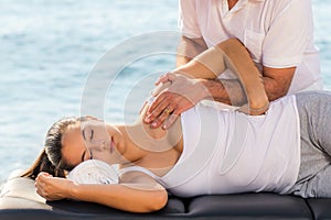 Woman having osteopathic treatment outdoors. photo