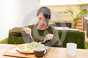 Woman having pancake in restaurant