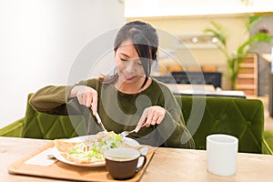 Woman having pancake in restaurant photo