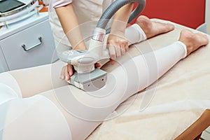 Woman having procedure of anti cellulite lpg massage, cosmetology clinic