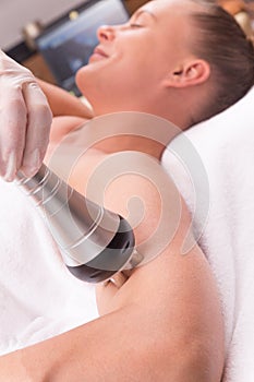 Woman having radio waves treatment.