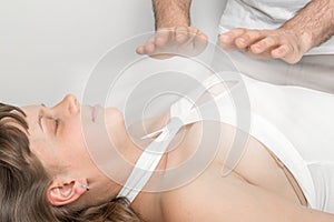 Woman is having reiki healing treatment