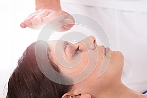 Woman Having Reiki Healing Treatment