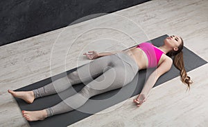 Woman having rest after training yoga in gym