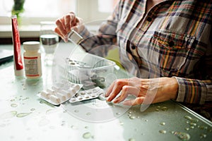 The woman having rheumatoid arthritis takes medicine.