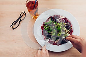 Woman having salad and apple juice in restaurant. Girl eating healthy food