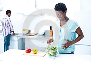 Woman having salad while standing
