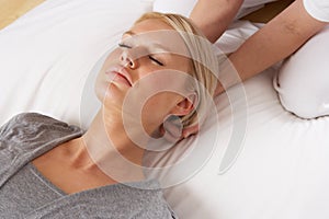 Woman having Shiatsu massage to head