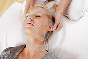 Woman having Shiatsu massage to head