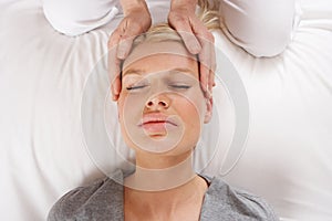 Woman having Shiatsu massage to head