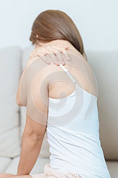 Woman having Shoulder and Neck pain at home. Muscle painful due to Myofascial pain syndrome and Fibromyalgia, rheumatism, Scapular