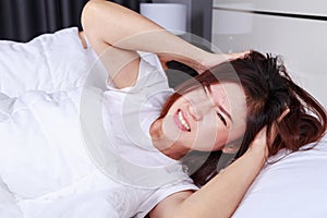 woman having sleepless on bed and having migraine,stress, insomnia, hangover in bedroom