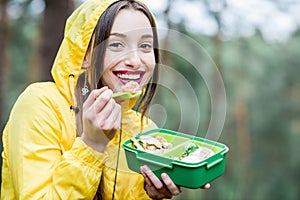 Woman having a snack in the forest