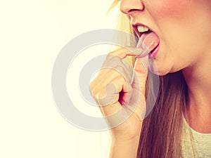 Woman having something disgusting on tongue