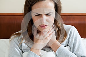 Woman having a sore throat