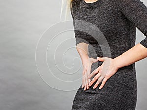 Woman having strong stomach ache. Syndroms photo