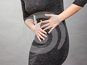 Woman having strong stomach ache. Syndroms photo