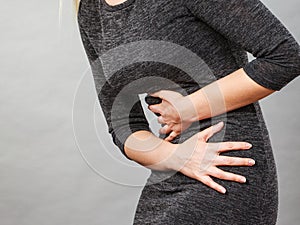 Woman having strong stomach ache. Syndroms photo