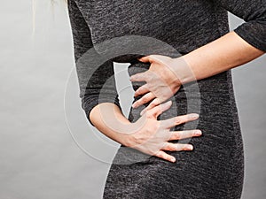 Woman having strong stomach ache. Syndroms photo