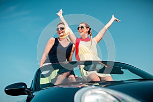Woman having summer trip in convertible car