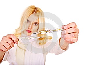 Woman having taking thermometer.