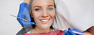 Woman having teeth examined at dentist.