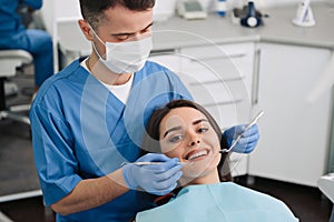 Woman having teeth examined at dentists