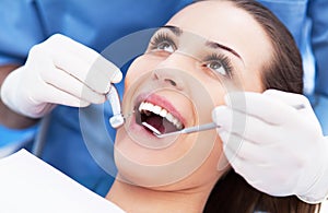 Woman having teeth examined at dentists