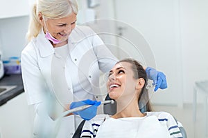 Dentist and patient in dentist office photo