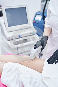 Woman having ultrasound lifting procedure in beauty center