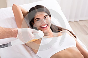 Woman Having Underarm Laser Hair Removal Treatment