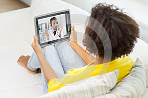 Woman having video call with doctor on tablet pc