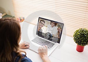 Woman having video call with friends on laptop