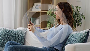 woman having video call on tablet pc at home