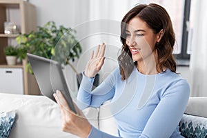 woman having video call on tablet pc at home