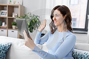 woman having video call on tablet pc at home