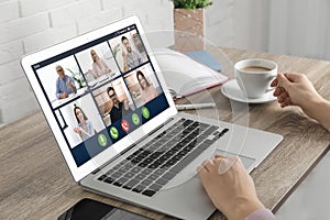 Woman having video chat with colleagues at table in office, closeup. Team work