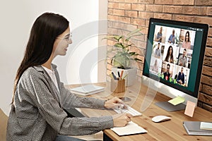 Woman having video chat with colleagues at table. Team work